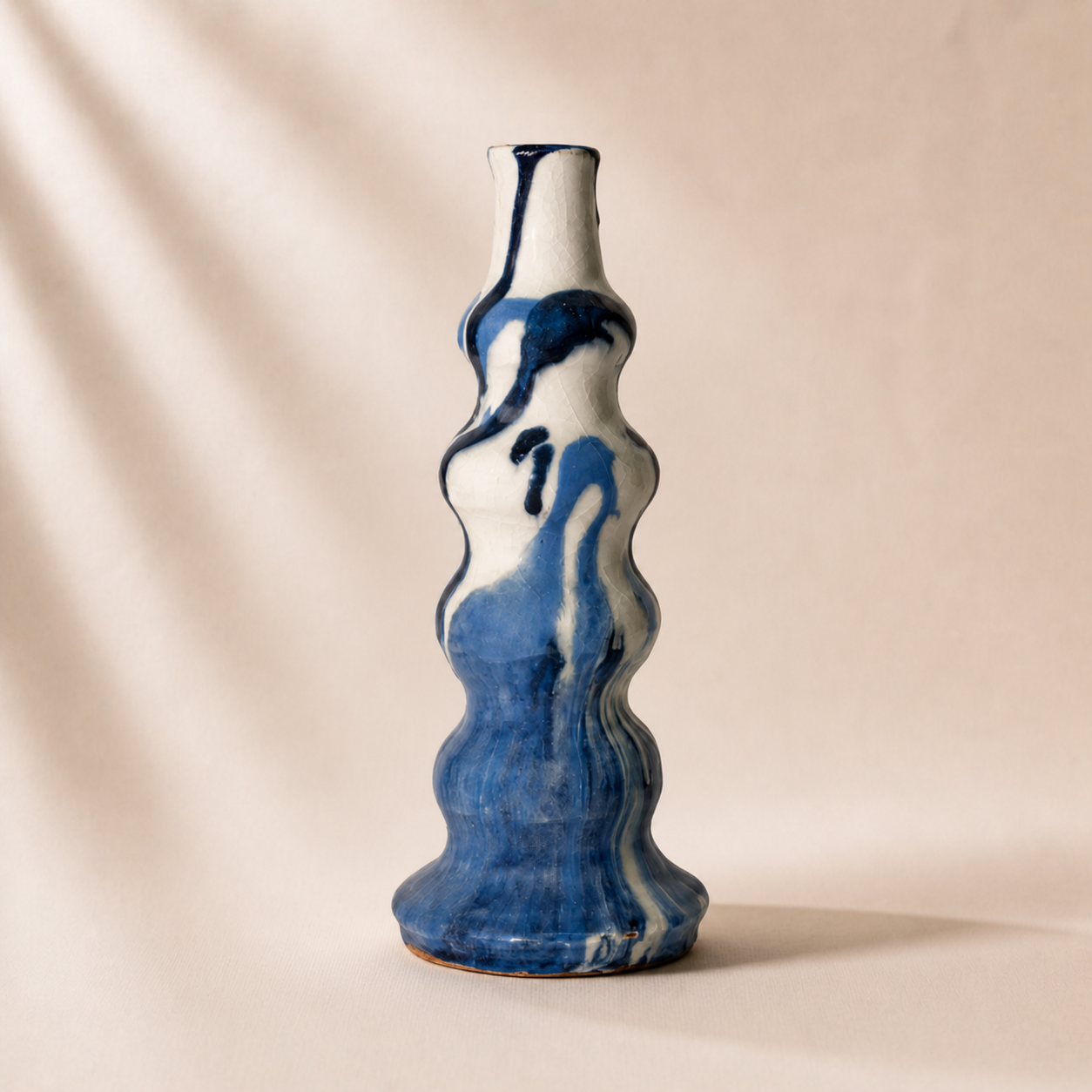 Blue and white ceramic vase on a beige background