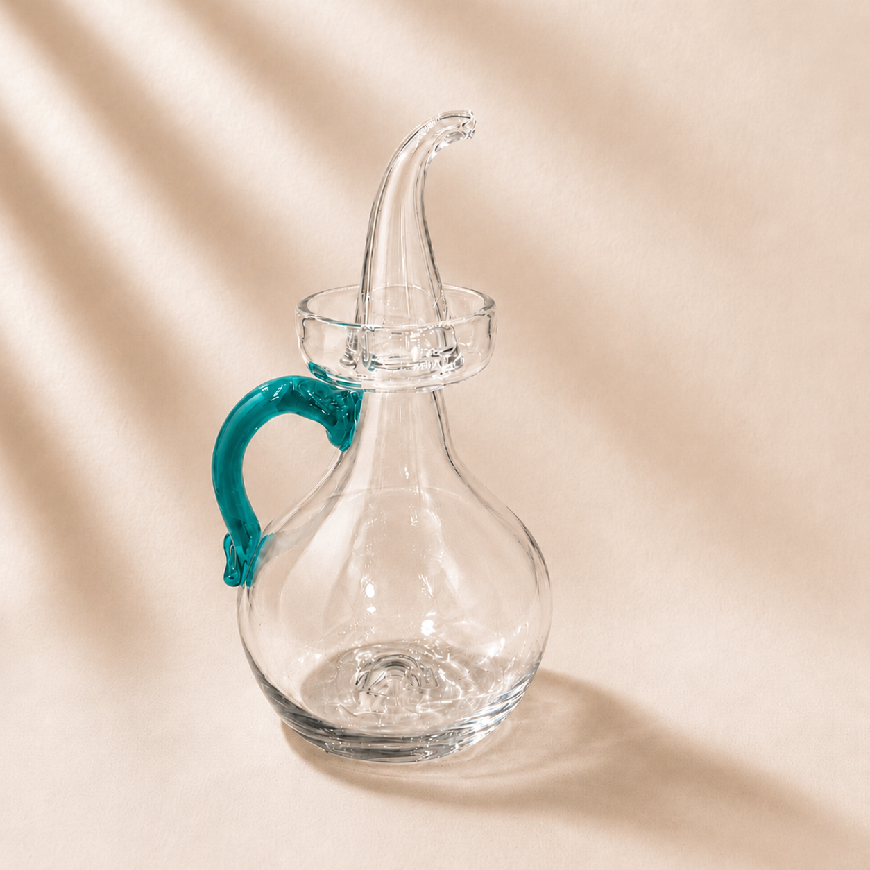 Olive cruet with a turquoise handle on a beige background