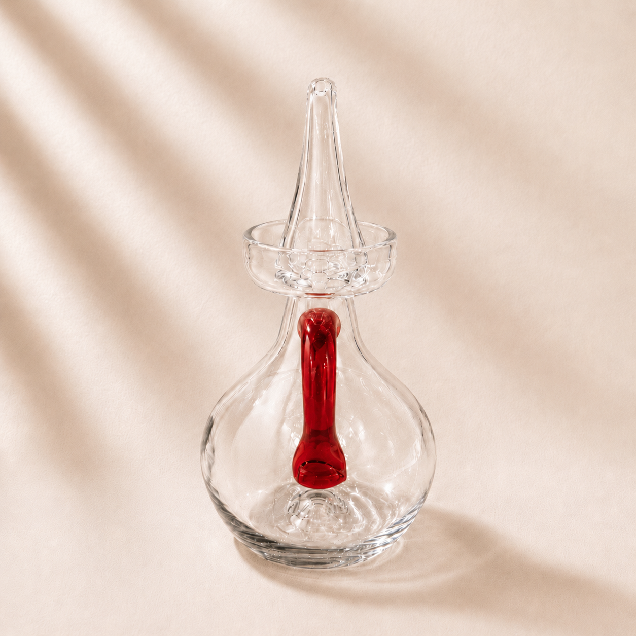 Olive cruet with  oil dispenser with red handle on a beige background