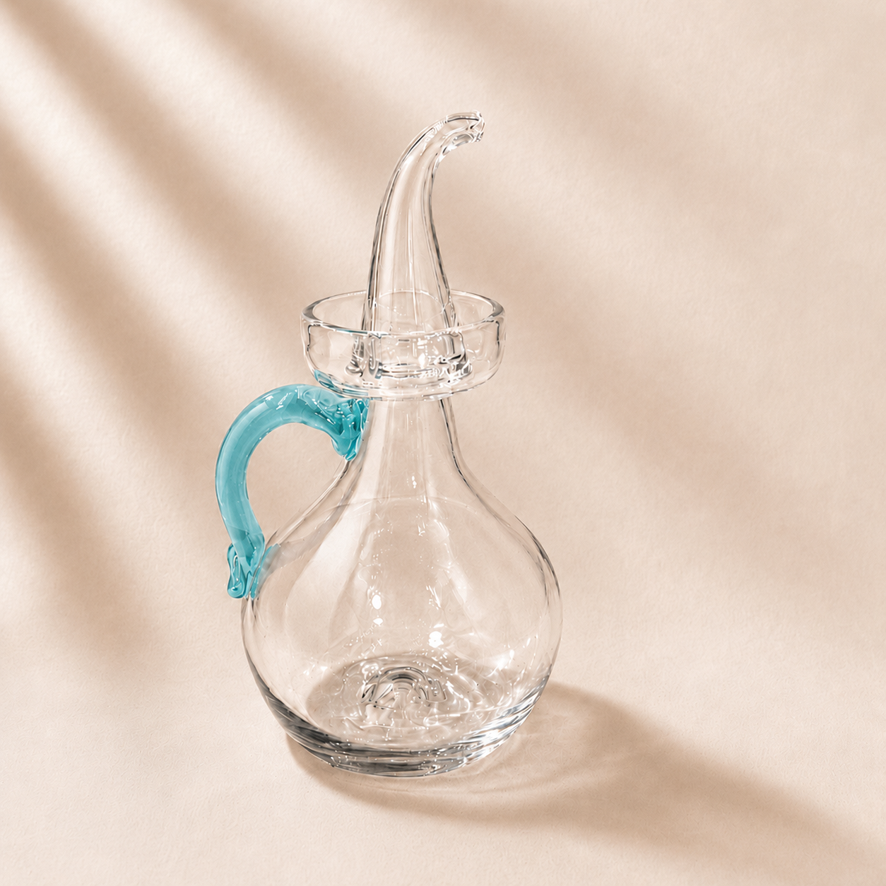 Olive Cruet with a blue handle on a beige background