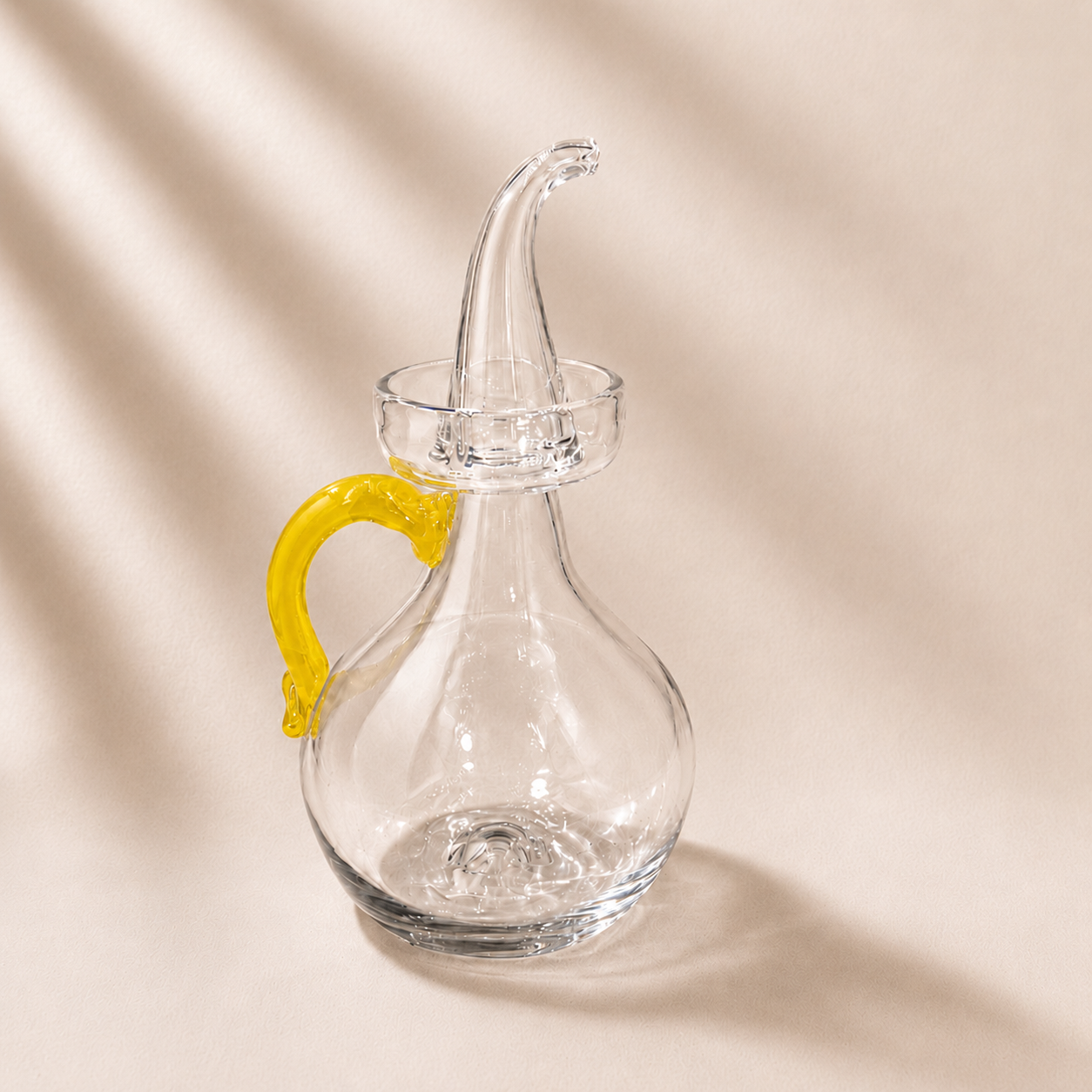 Olive cruet with a yellow handle on a beige background