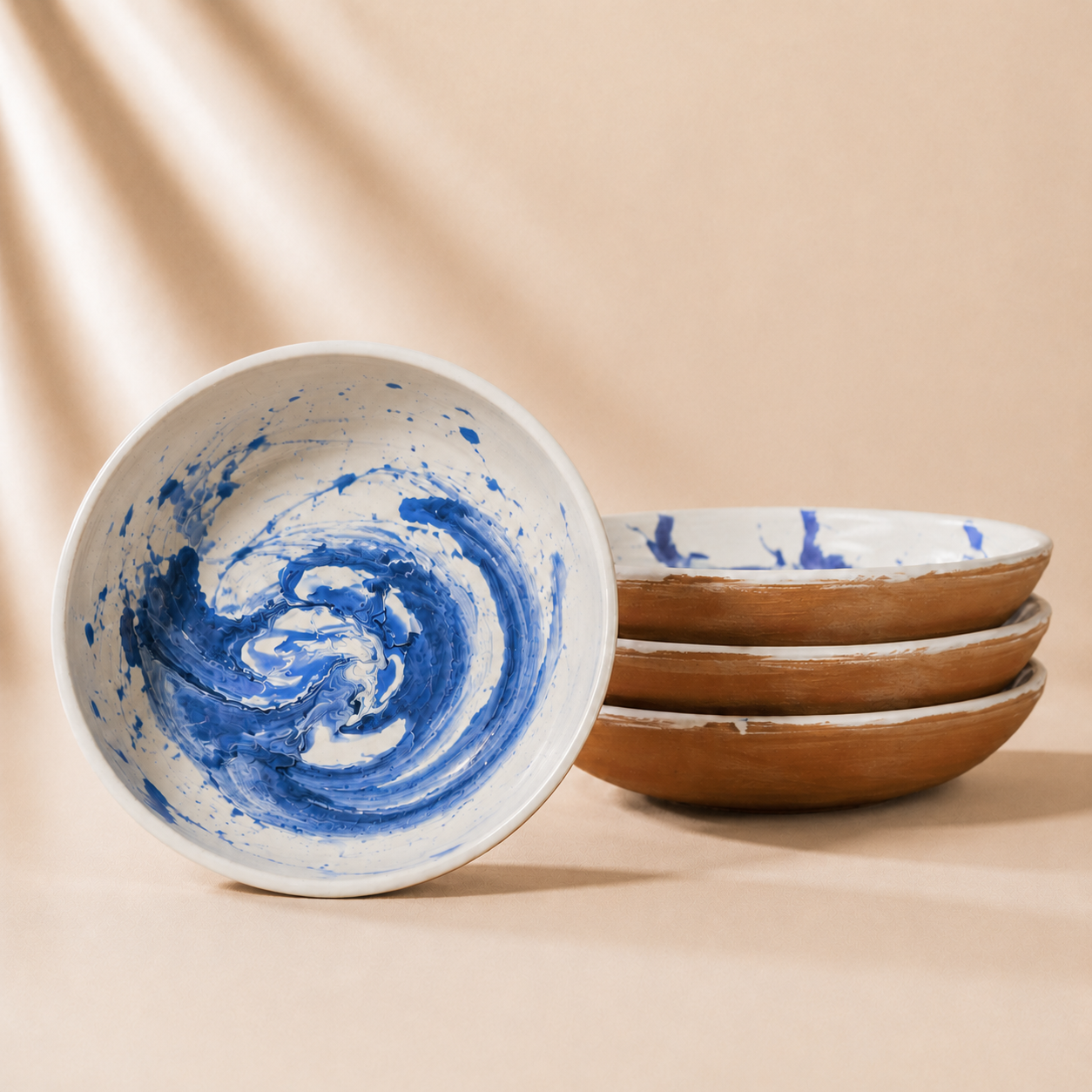 Ceramic bowls with blue and white swirl patterns on a beige background