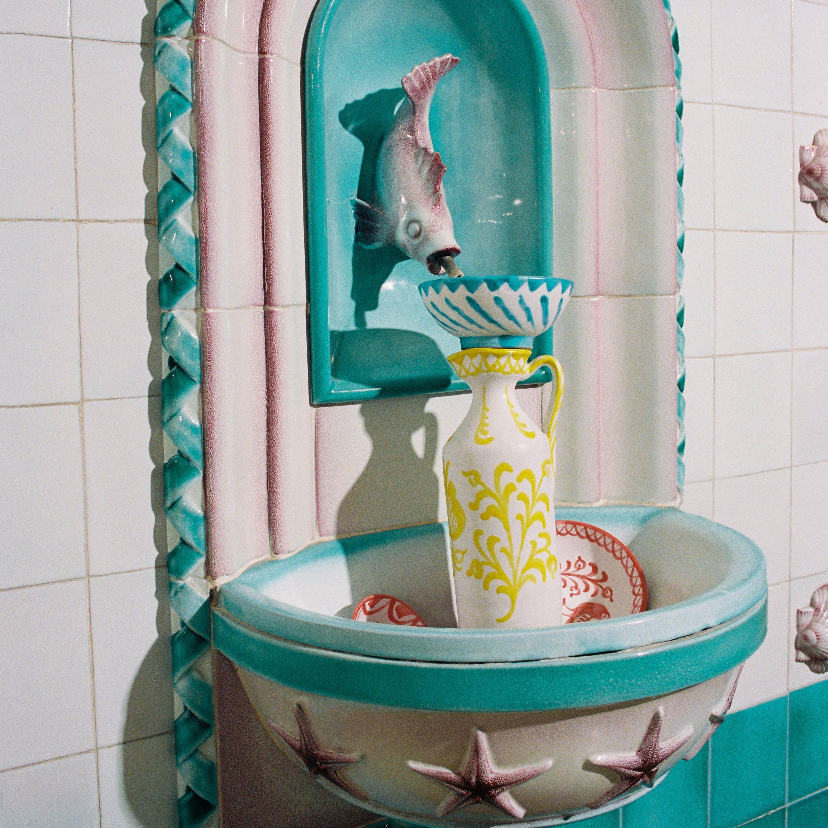 Decorative wall fountain with tiled surround in a bathroom setting - lifestyle