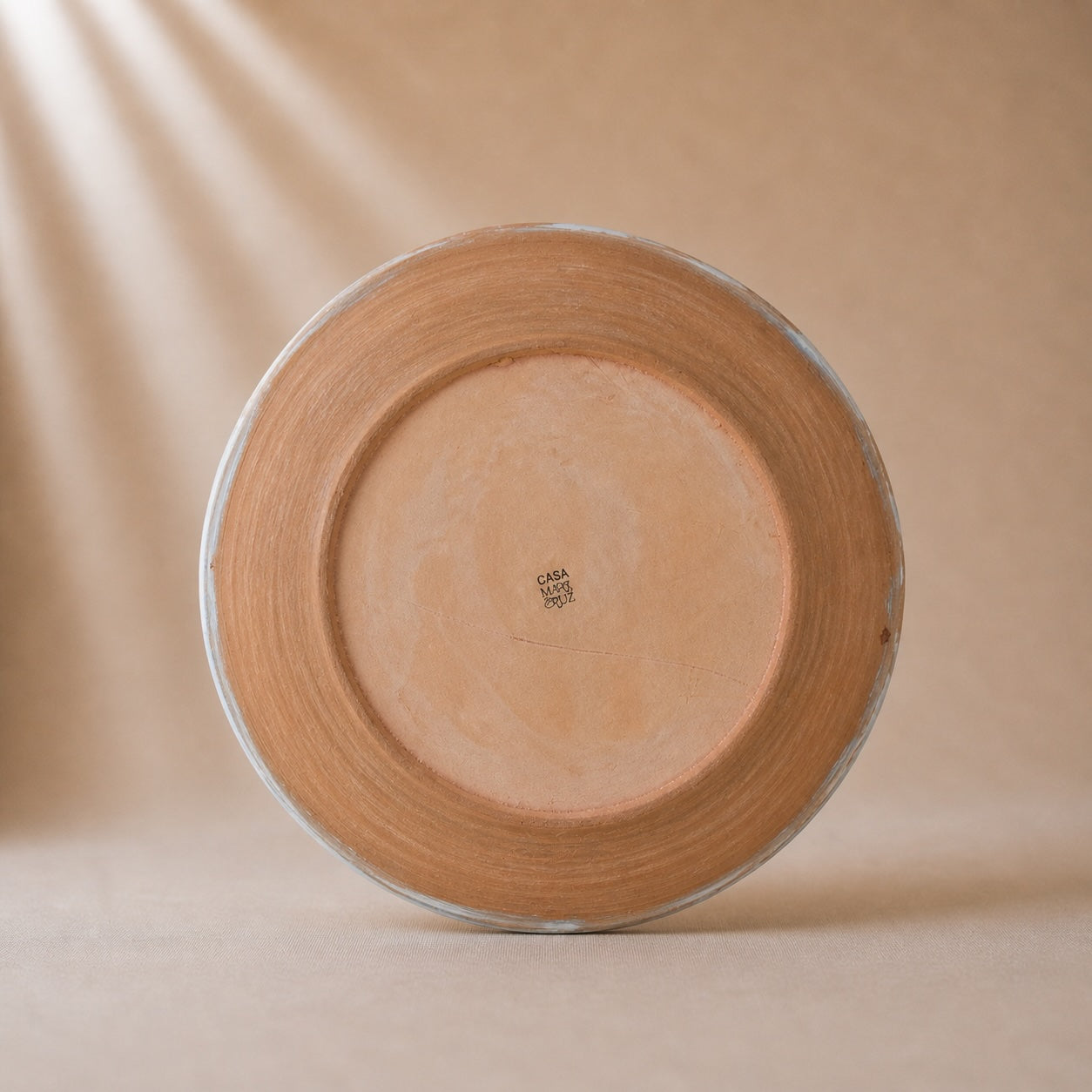 Ceramic vase with 'Casa Maricruz' branding on a beige background