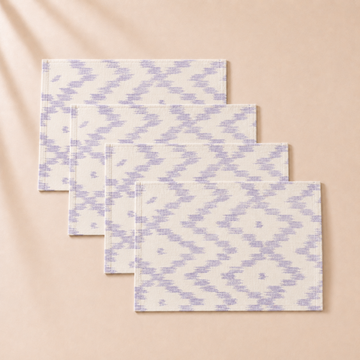 Set of fourpatterned placemats  on a beige background