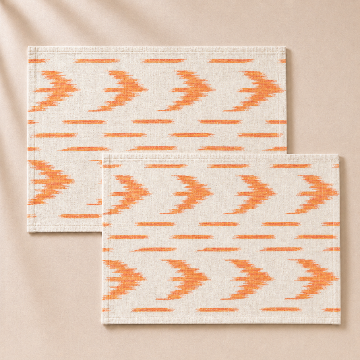 Two orange and white patterned placemats on a beige background