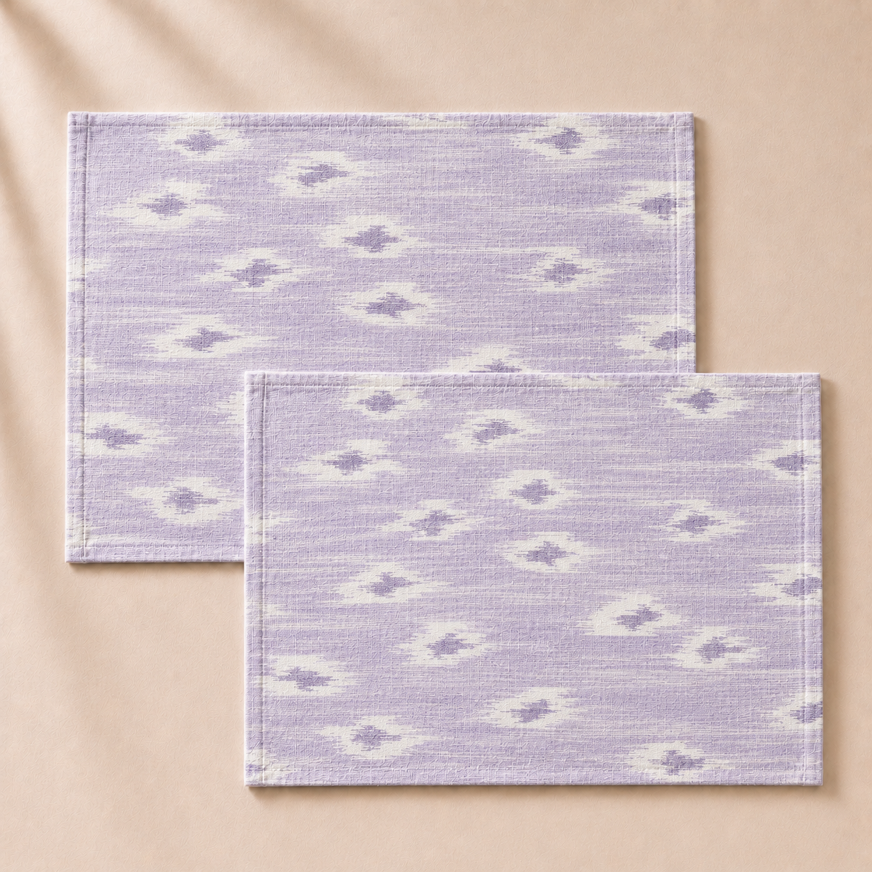 Two purple patterned placemats on a beige background