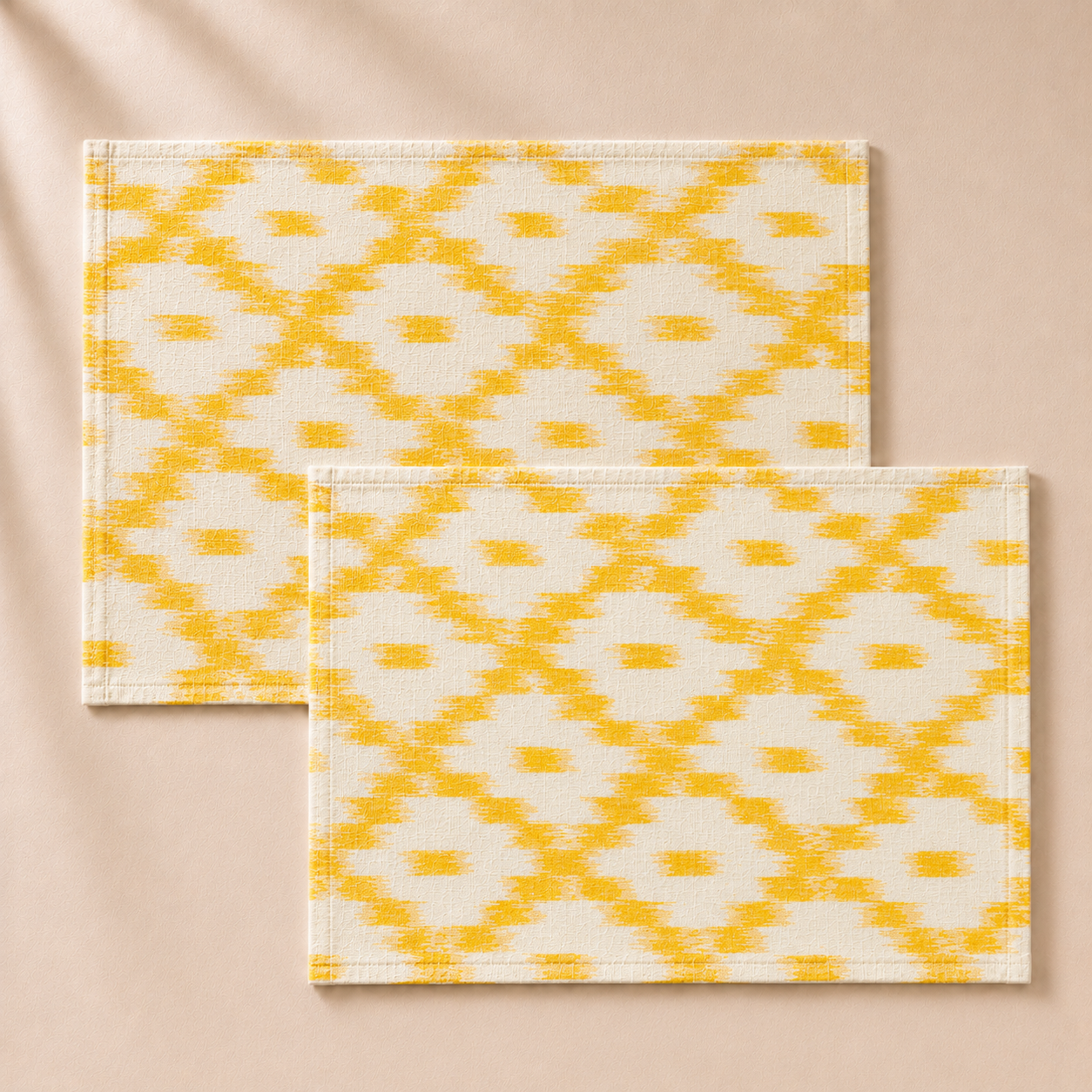 Two yellow and white patterned placemats on a beige background