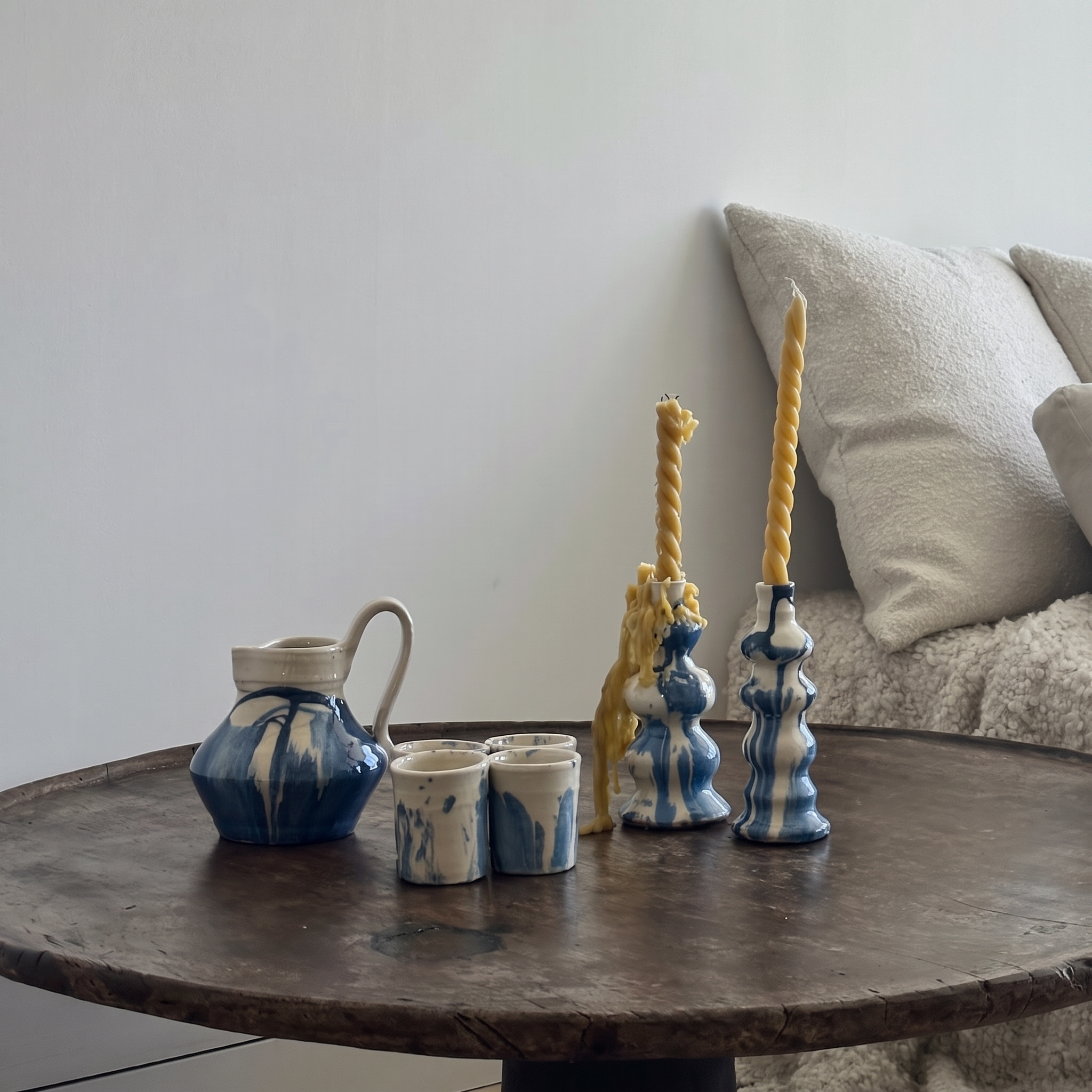 cups, candles and pitcher set in in table - lifestyle