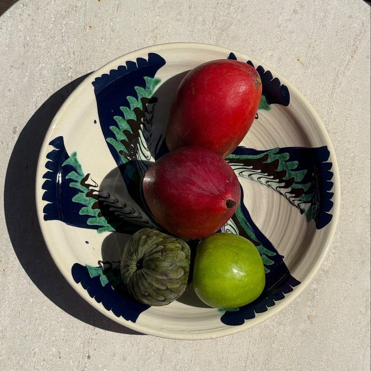 Decorative plate with fruits on a stone surface