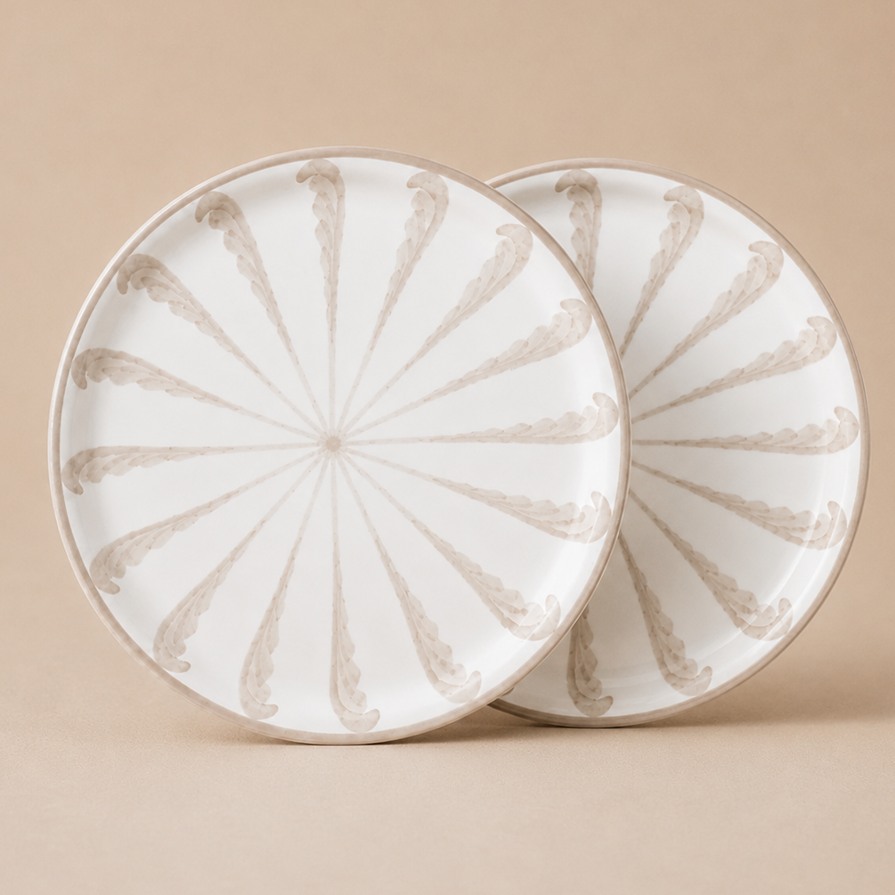 Two ceramic plates with decorative patterns on a beige background
