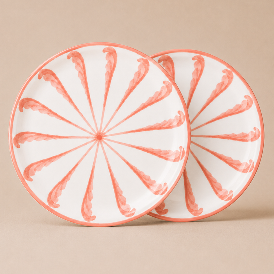 Two ceramic plates with a decorative pattern on a beige background