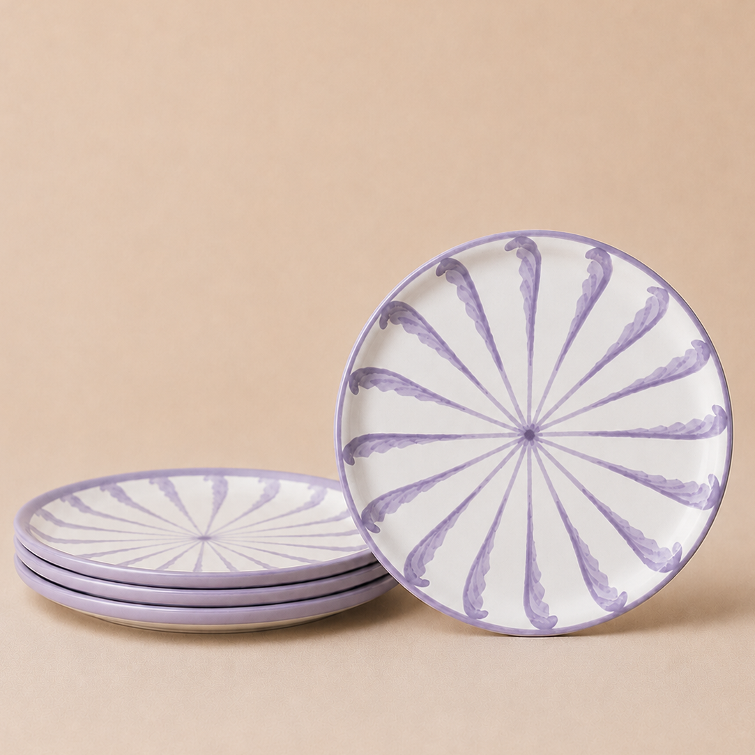 Set of ceramic plates with purple decorative patterns on a beige background