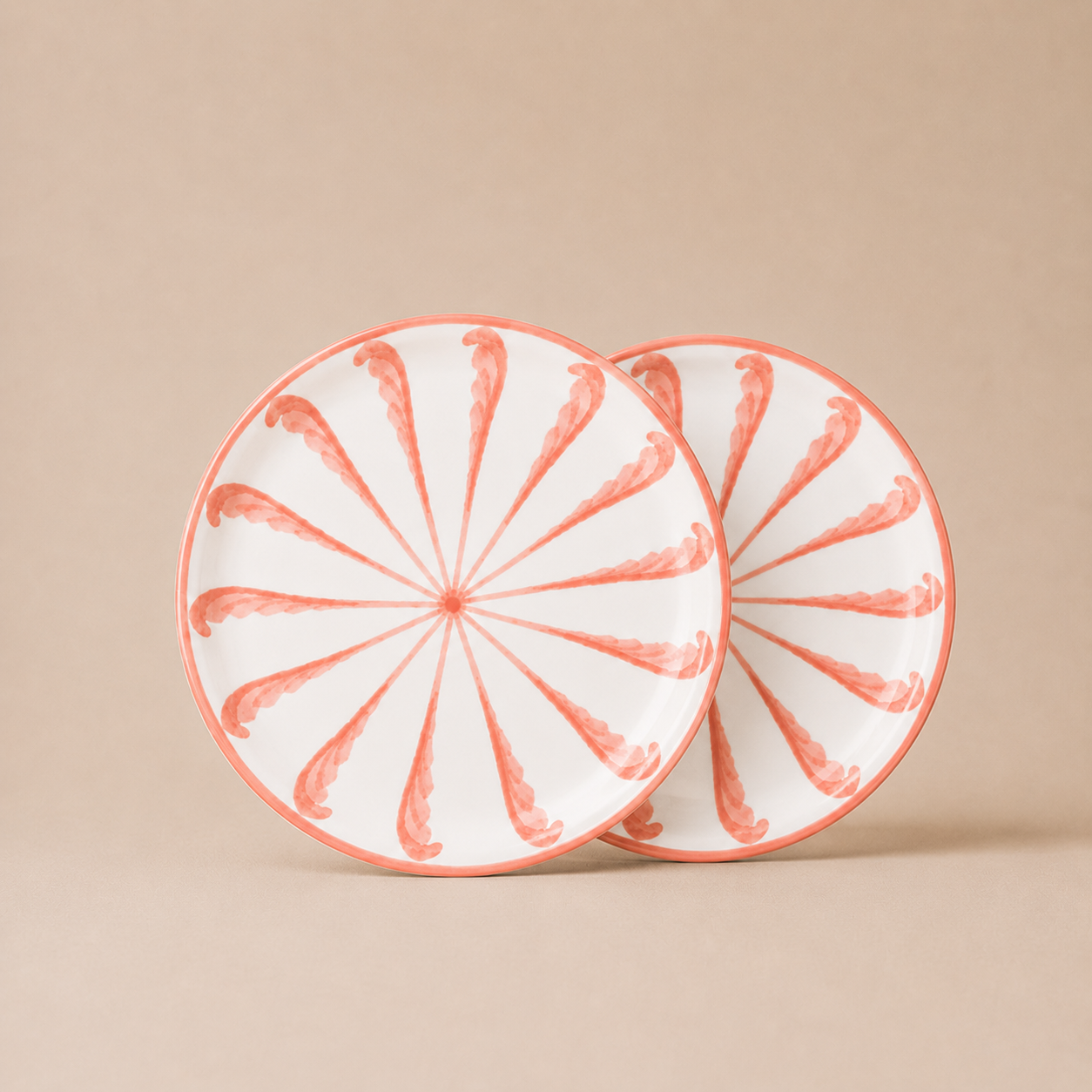 Two ceramic plates with a decorative pattern on a beige background