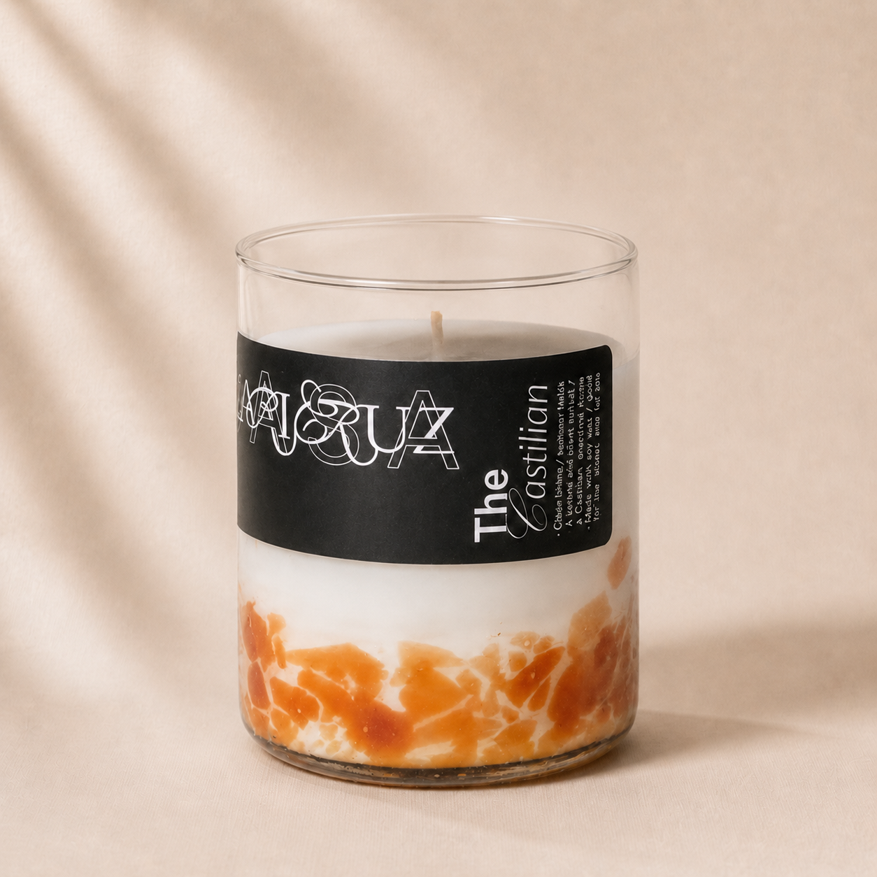Candle with a black label on a beige background