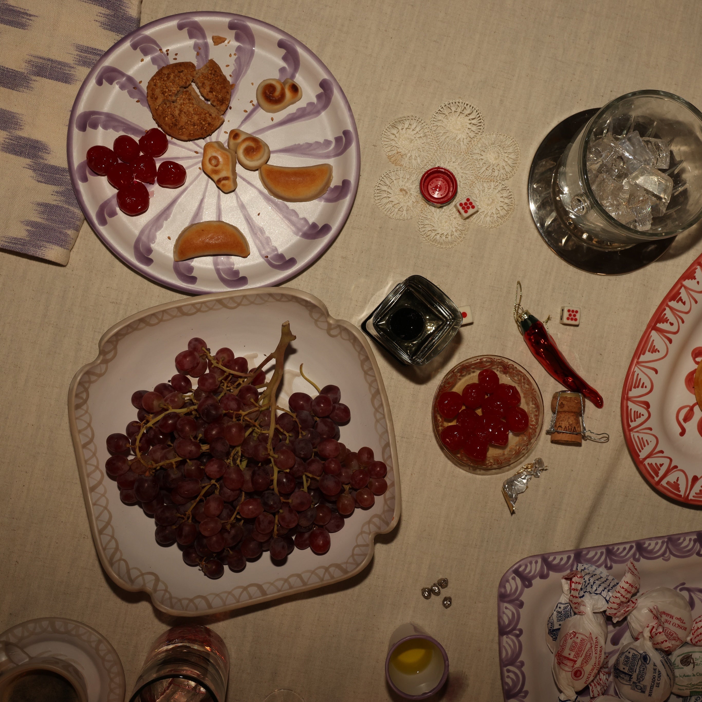 Decorative plates with fruit and a pitcher on a tablecloth