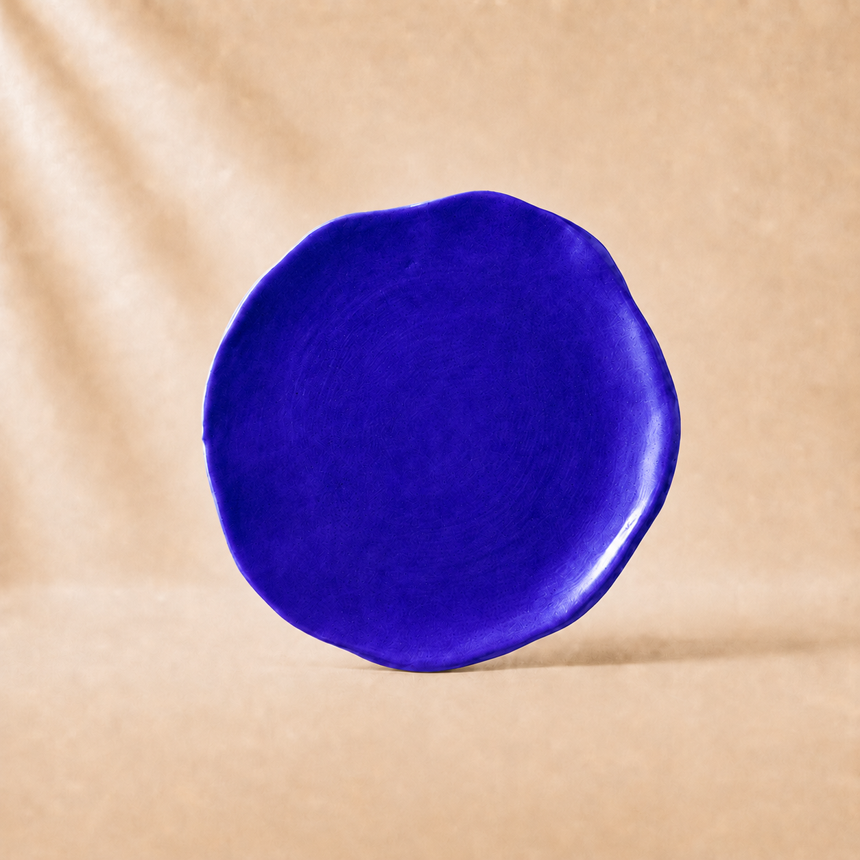 Blue circular object on a beige background