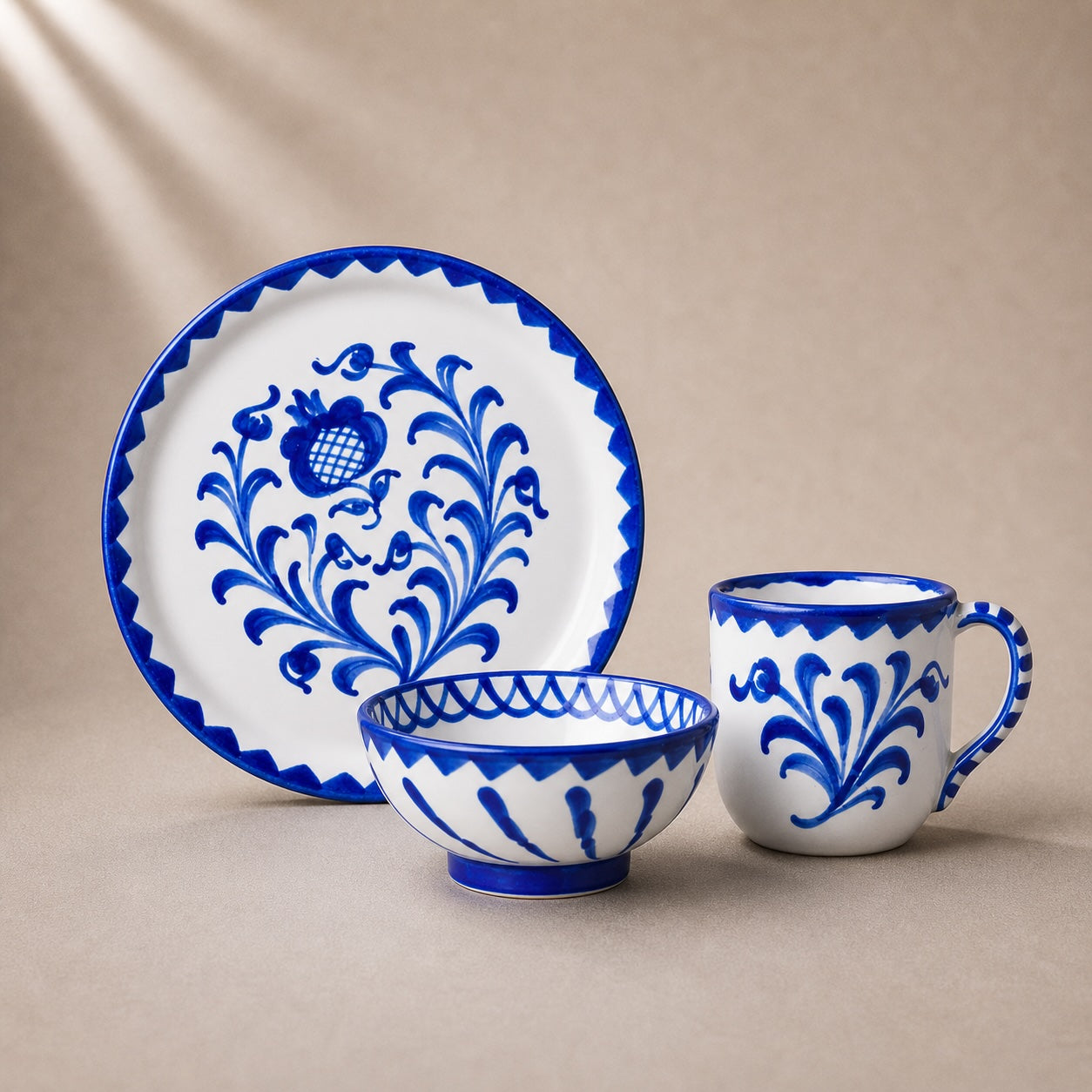 Ceramic tableware set with blue floral patterns on a beige background