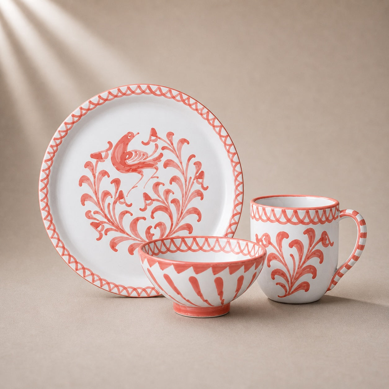 Ceramic tableware set with red floral patterns on a beige background