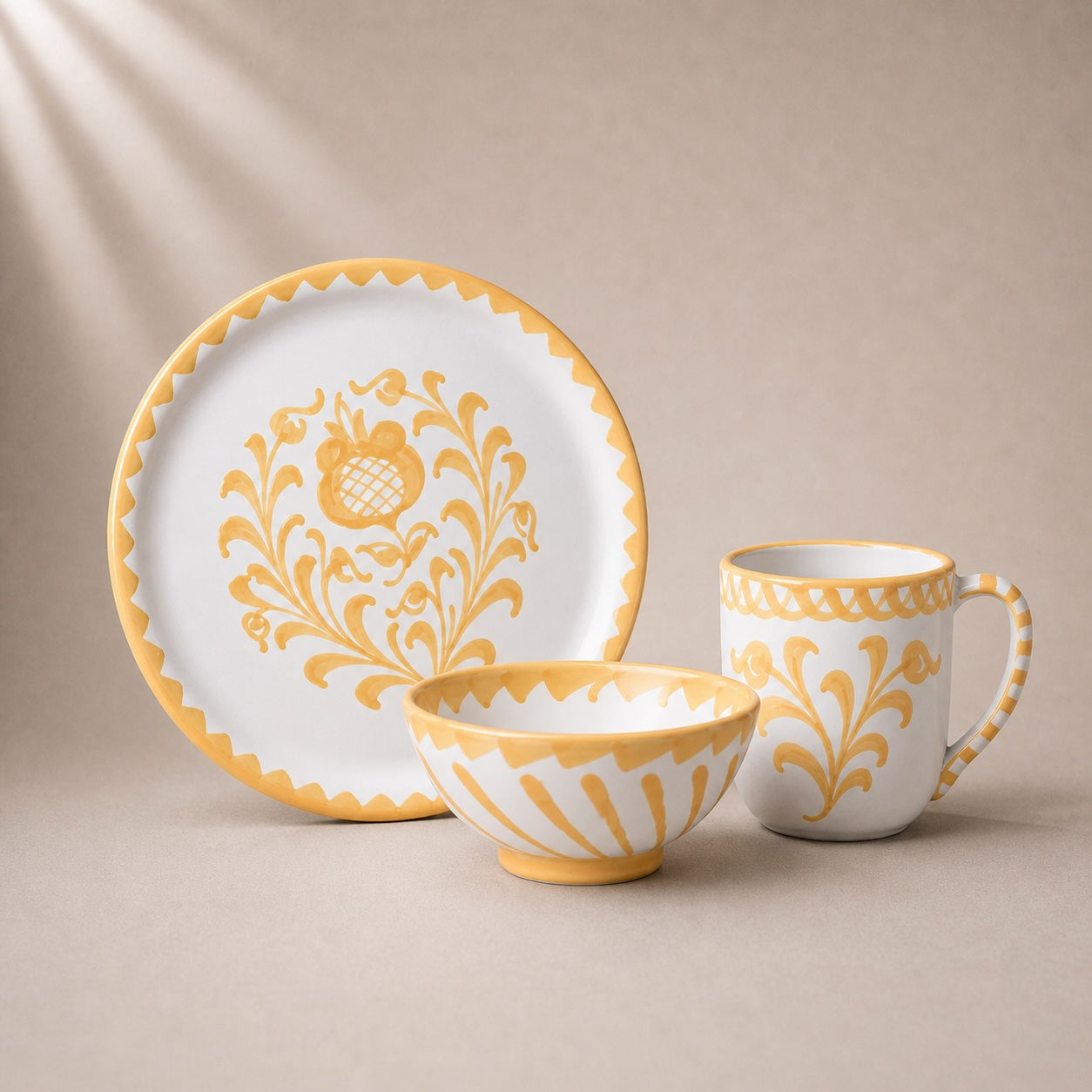 Ceramic tableware set with yellow floral patterns on a beige background