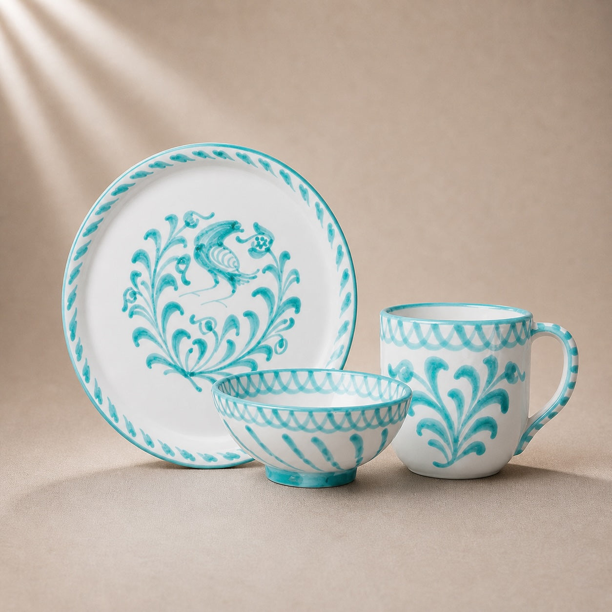 Ceramic tableware set with turquoise patterns on a beige background