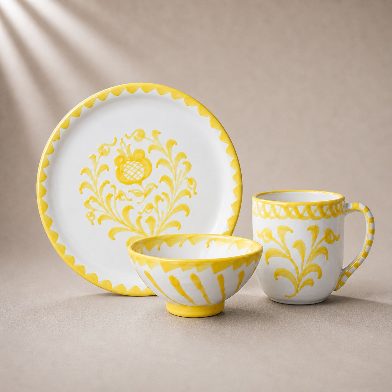 Ceramic tableware set with yellow floral patterns on a beige background