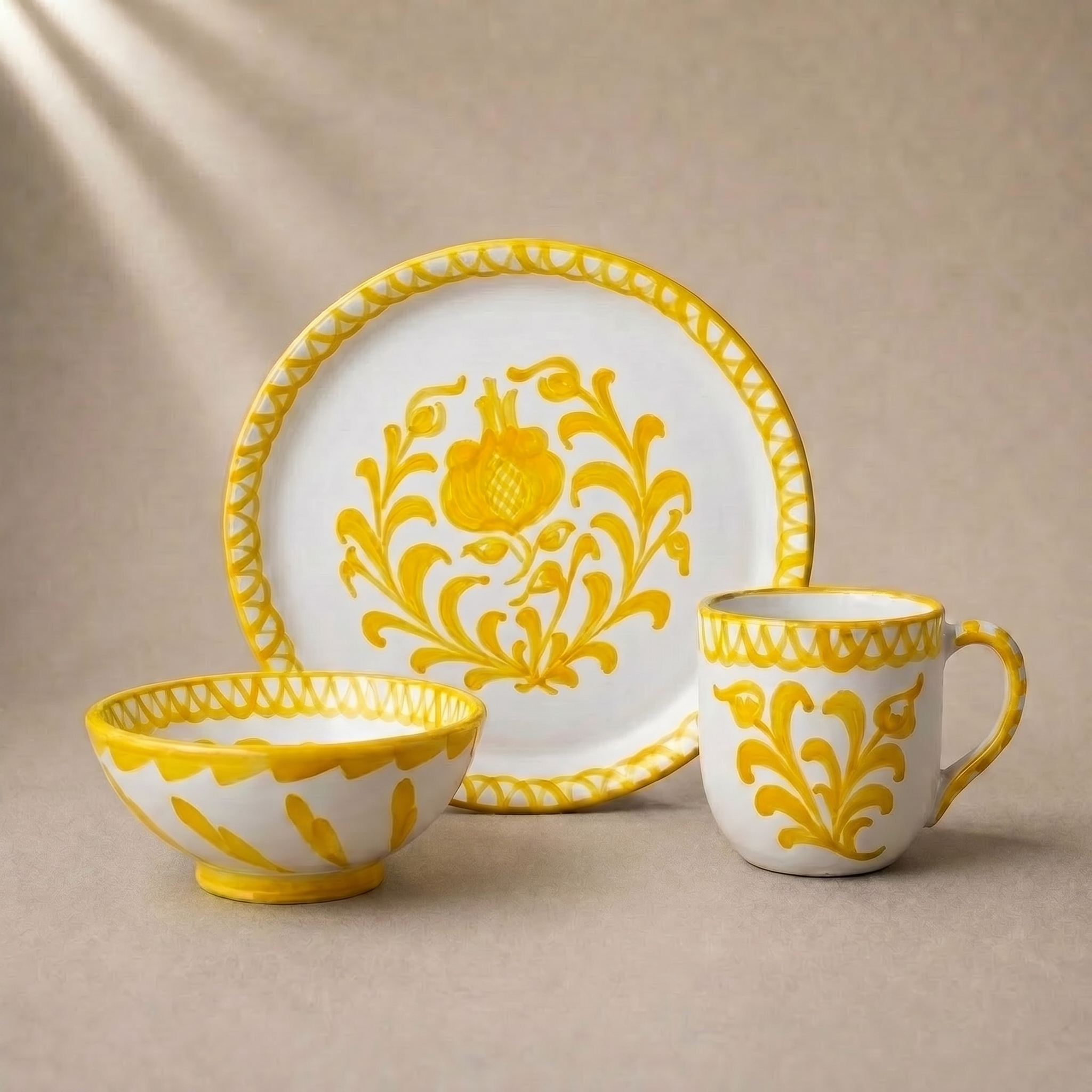 Ceramic tableware set with yellow floral patterns on a beige background