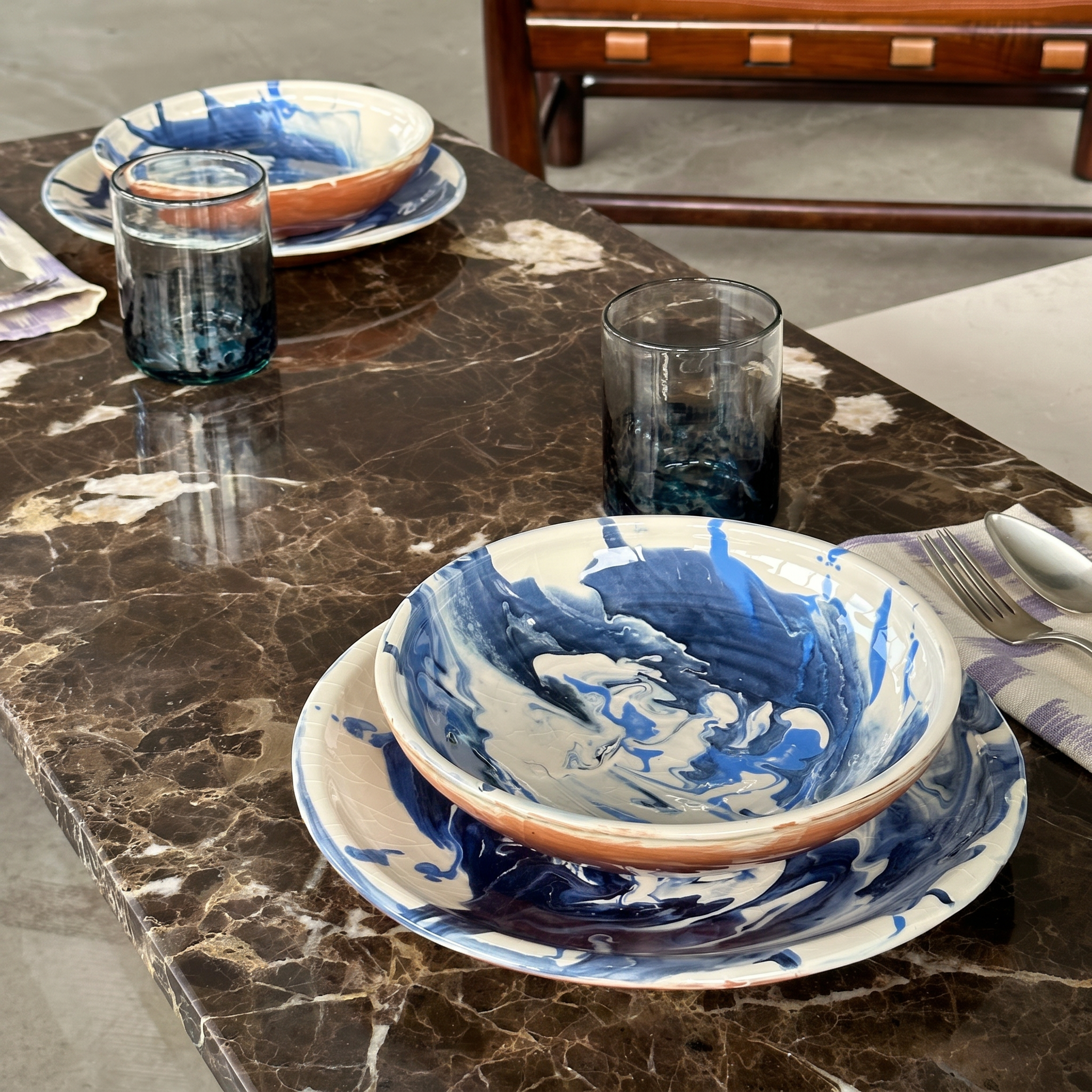 huelva blue set on brown barbled table - lifestyle