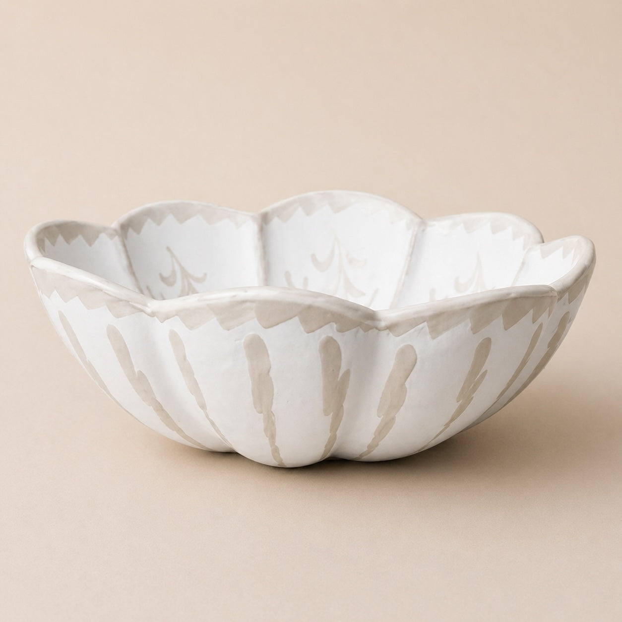 White ceramic bowl with a textured surface on a beige background