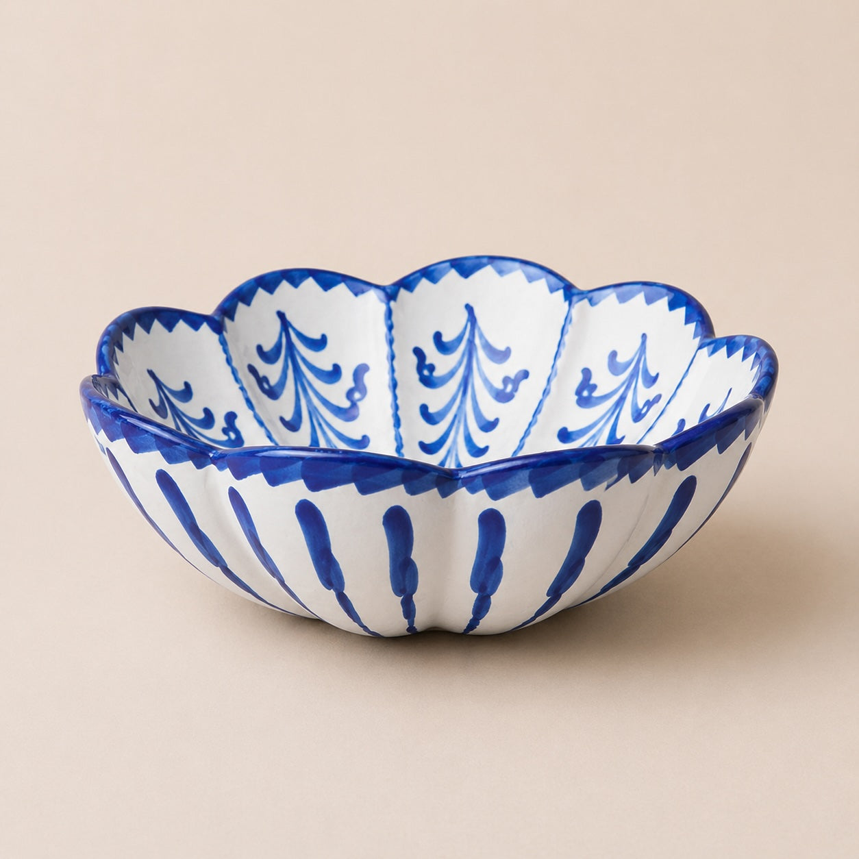 Ceramic bowl with blue and white floral patterns on a beige background