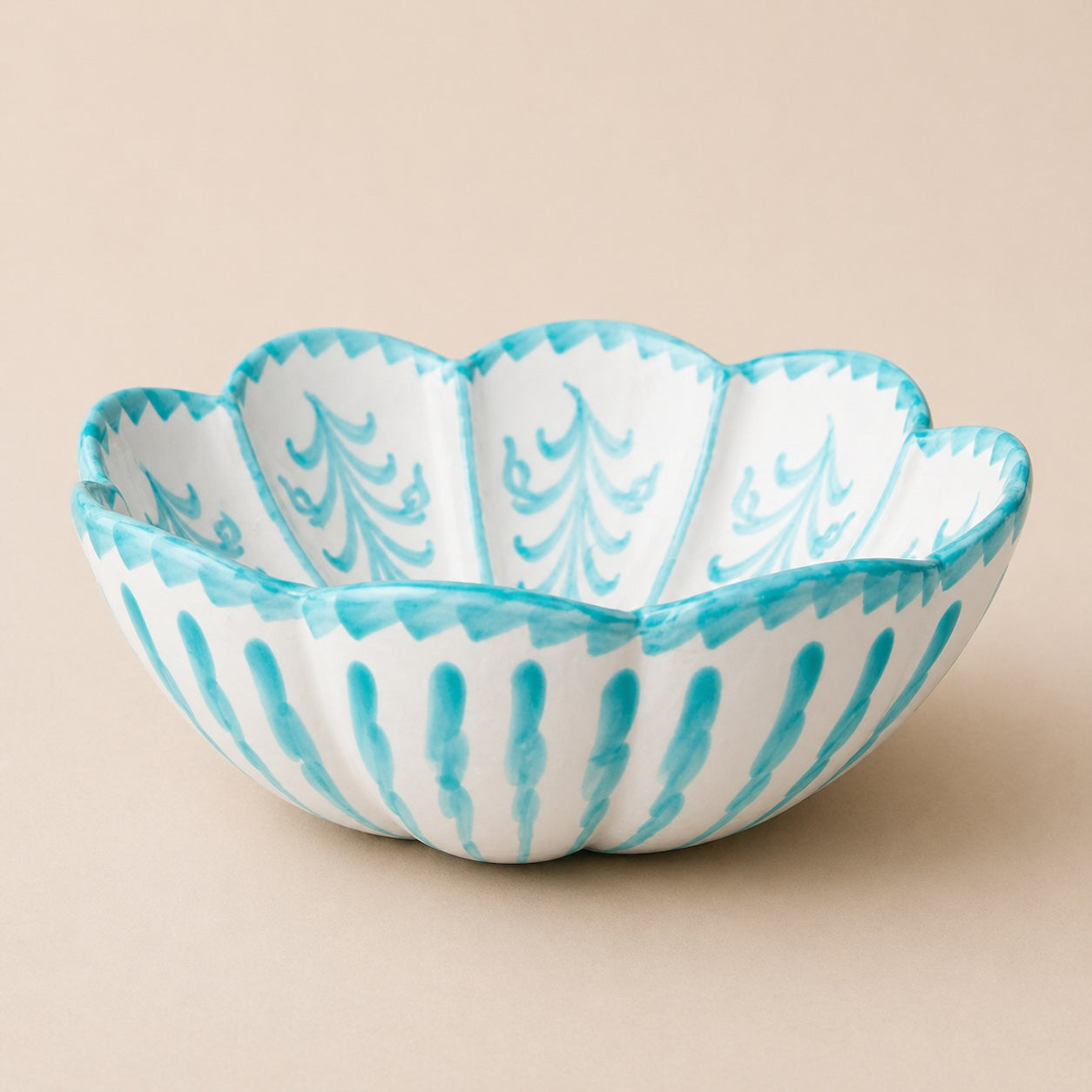 Decorative bowl with blue and white pattern on a beige background