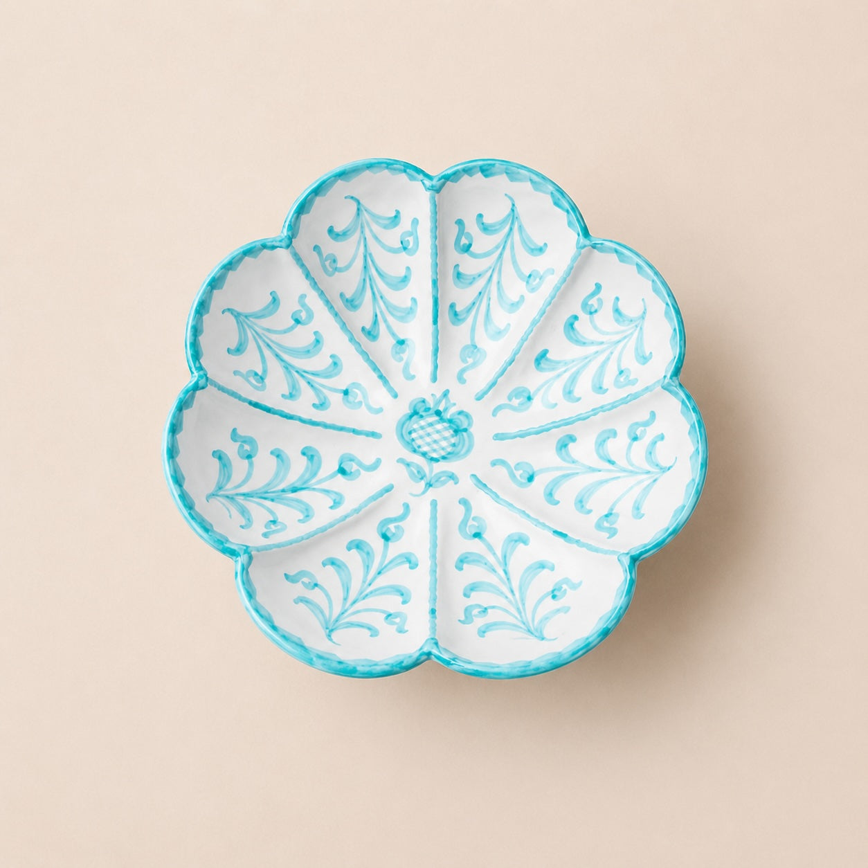 Decorative ceramic bowl with blue floral patterns on a beige background
