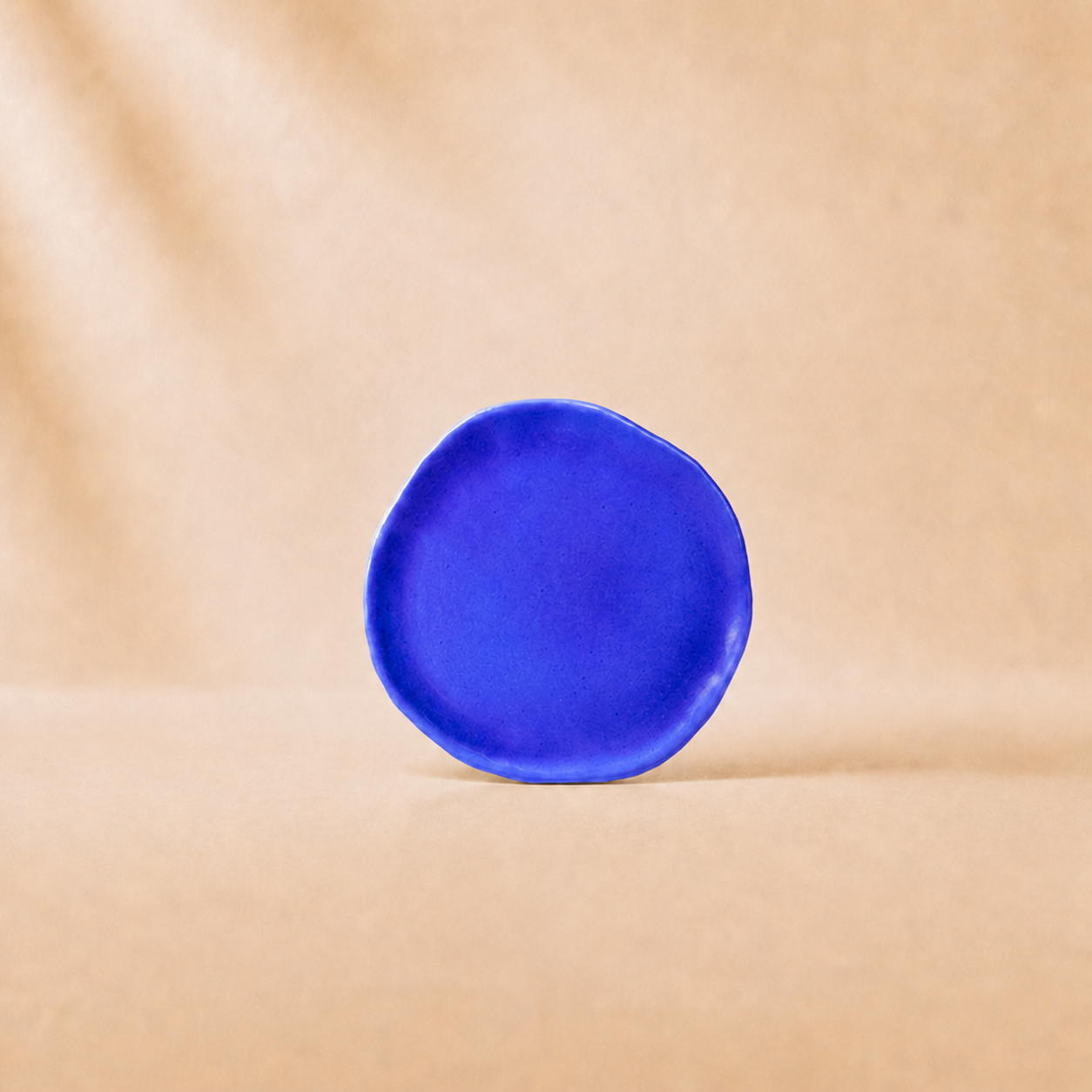 Blue ceramic plate on a beige background