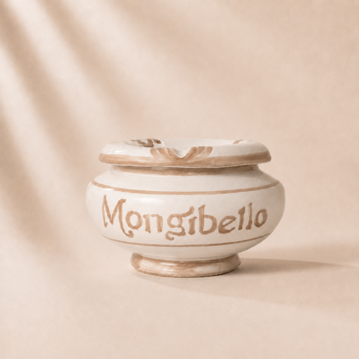 Ceramic jar with 'Mongibello' branding on a beige background