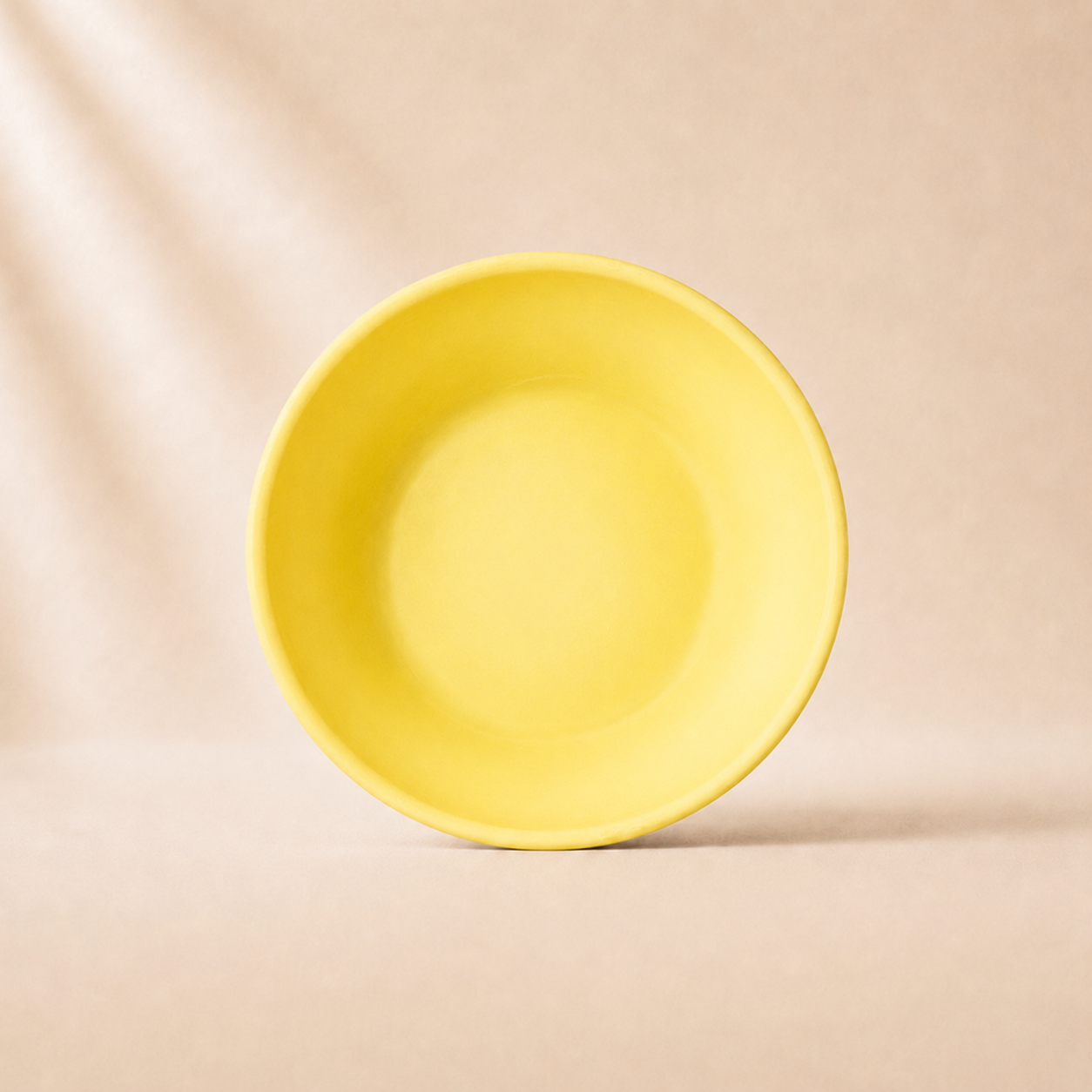 Yellow monochrome pasta bowl on a beige background