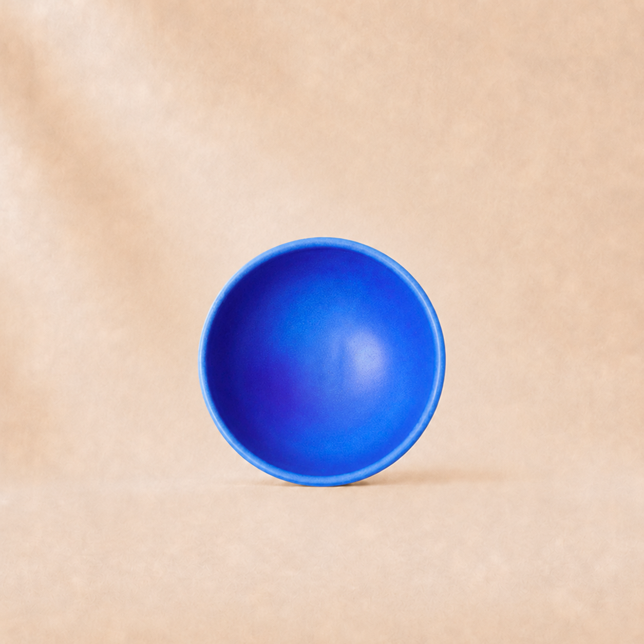 Blue bowl on a beige background