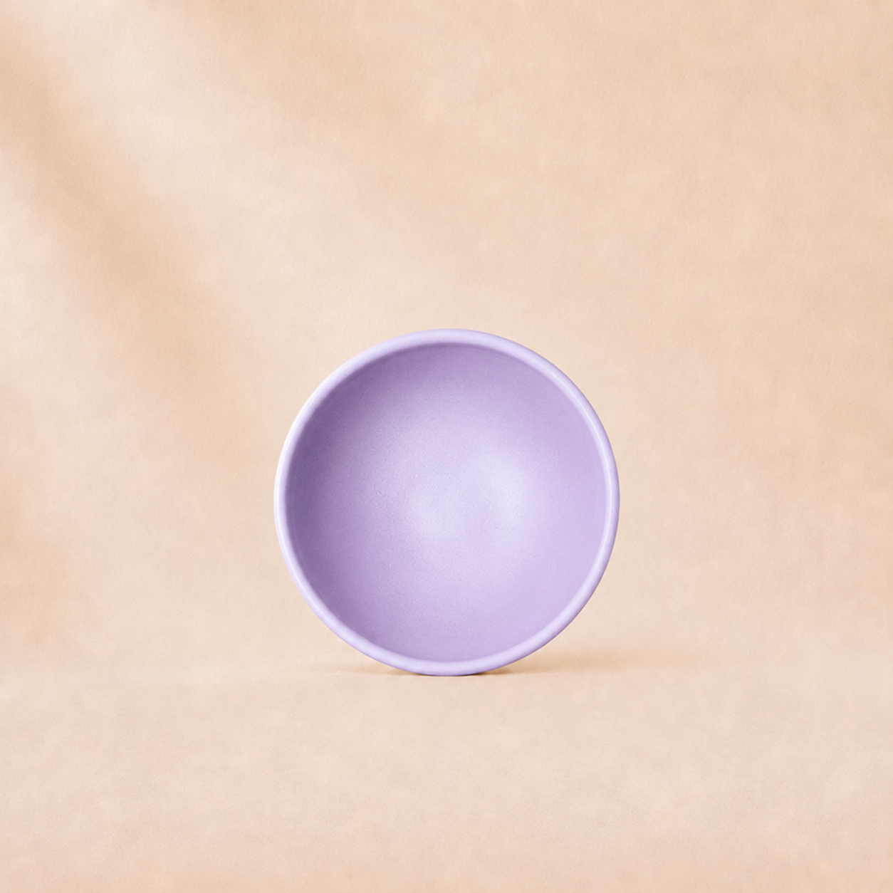 Purple bowl on a beige background