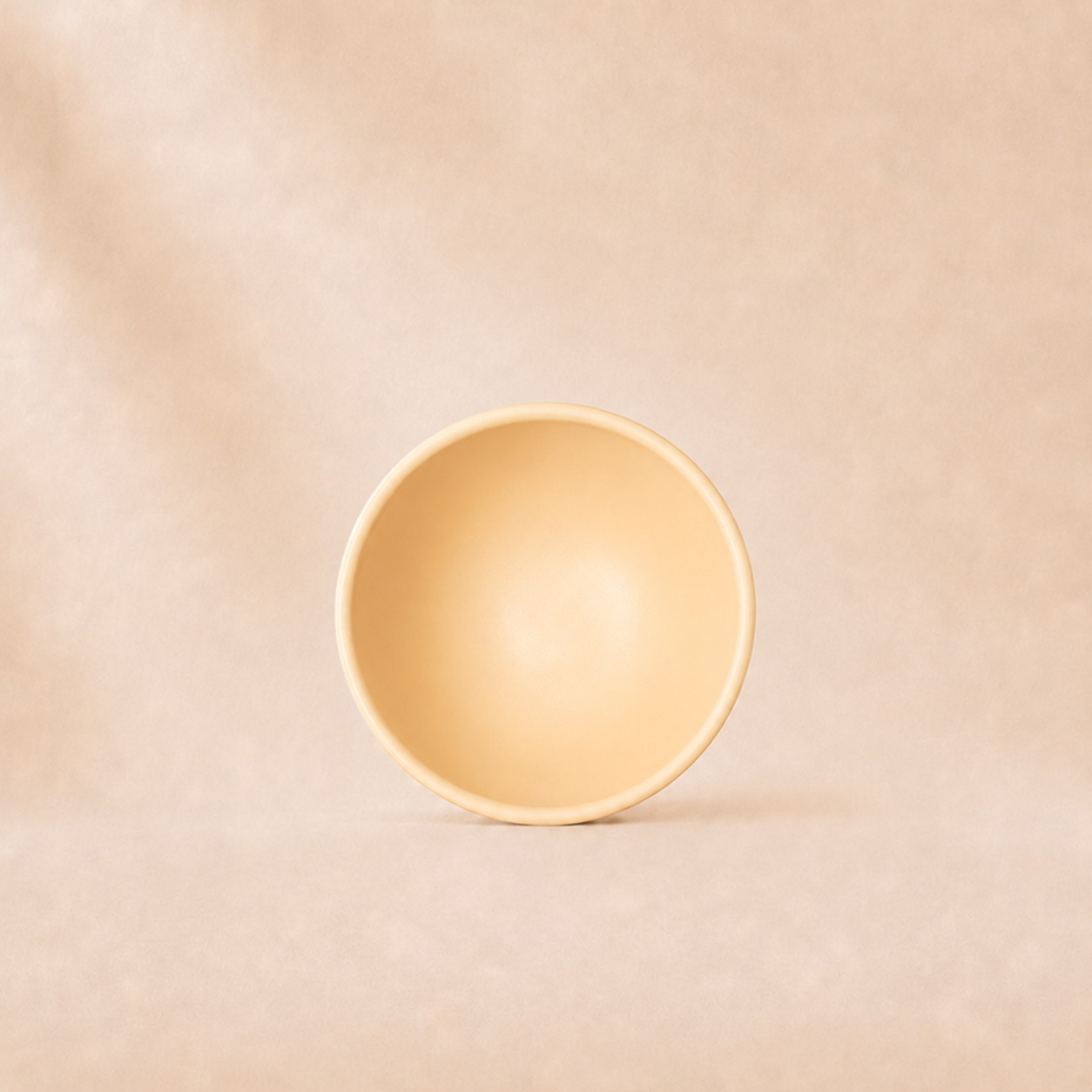 Beige ceramic bowl on a beige background