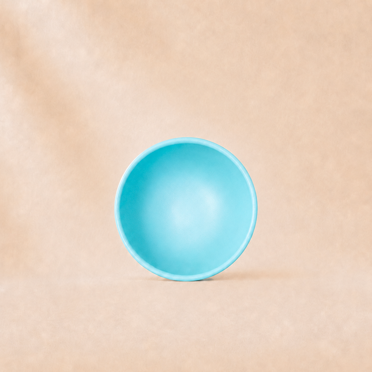 turquoise cereal bowl on a beige background