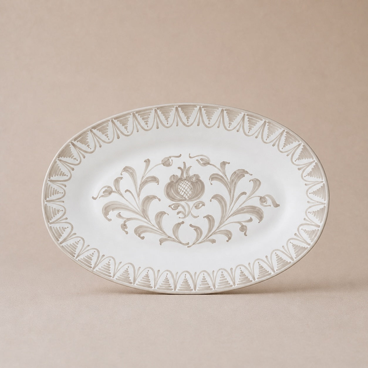 Decorative white plate with floral patterns on a beige background