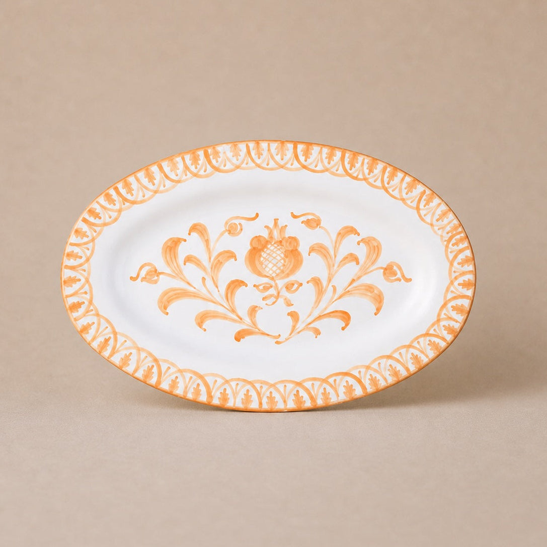 Decorative plate with orange floral pattern on a beige background