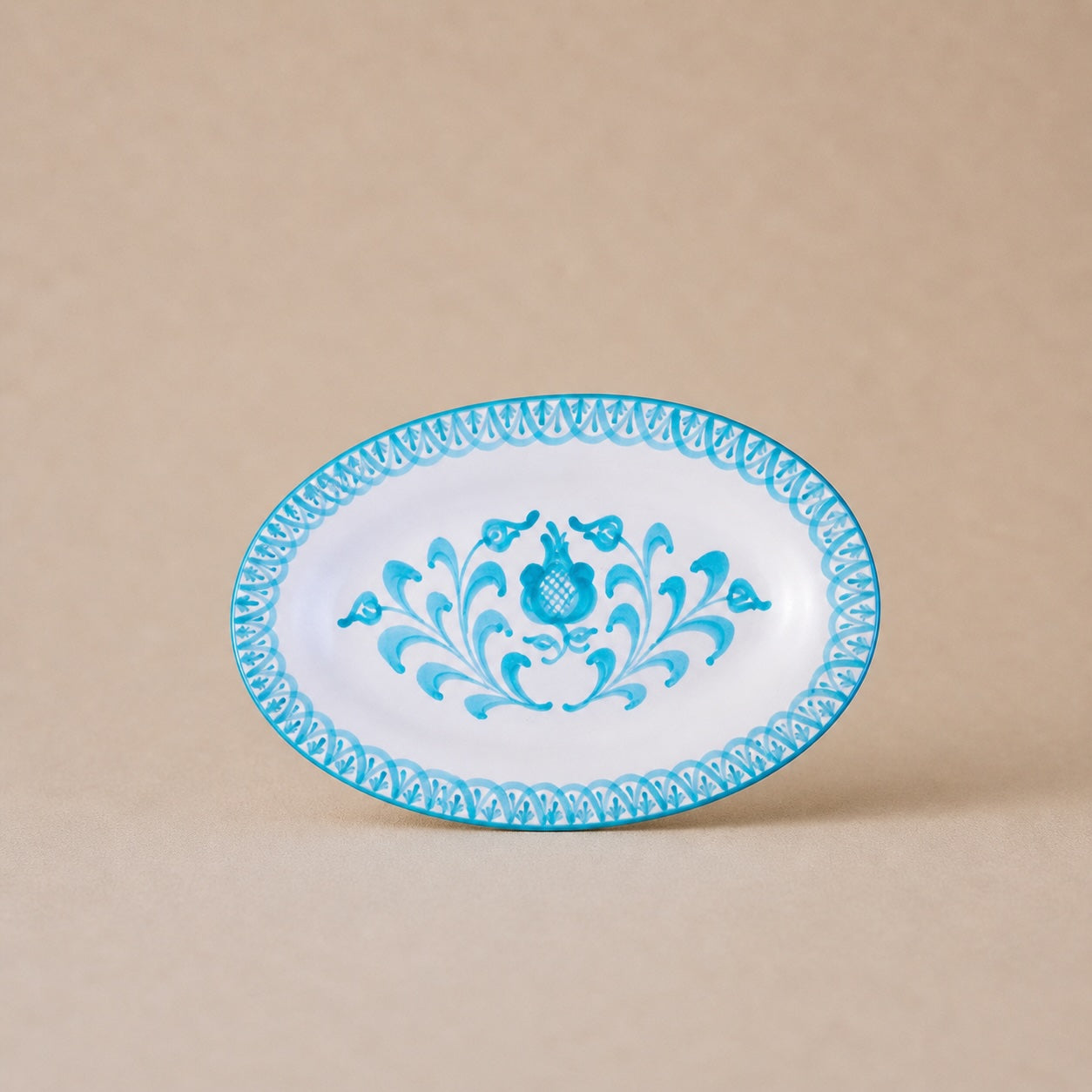 Decorative plate with blue floral design on a beige background