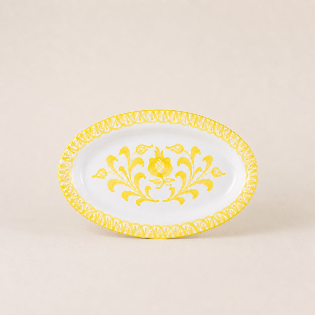 Decorative plate with yellow floral design on a beige background