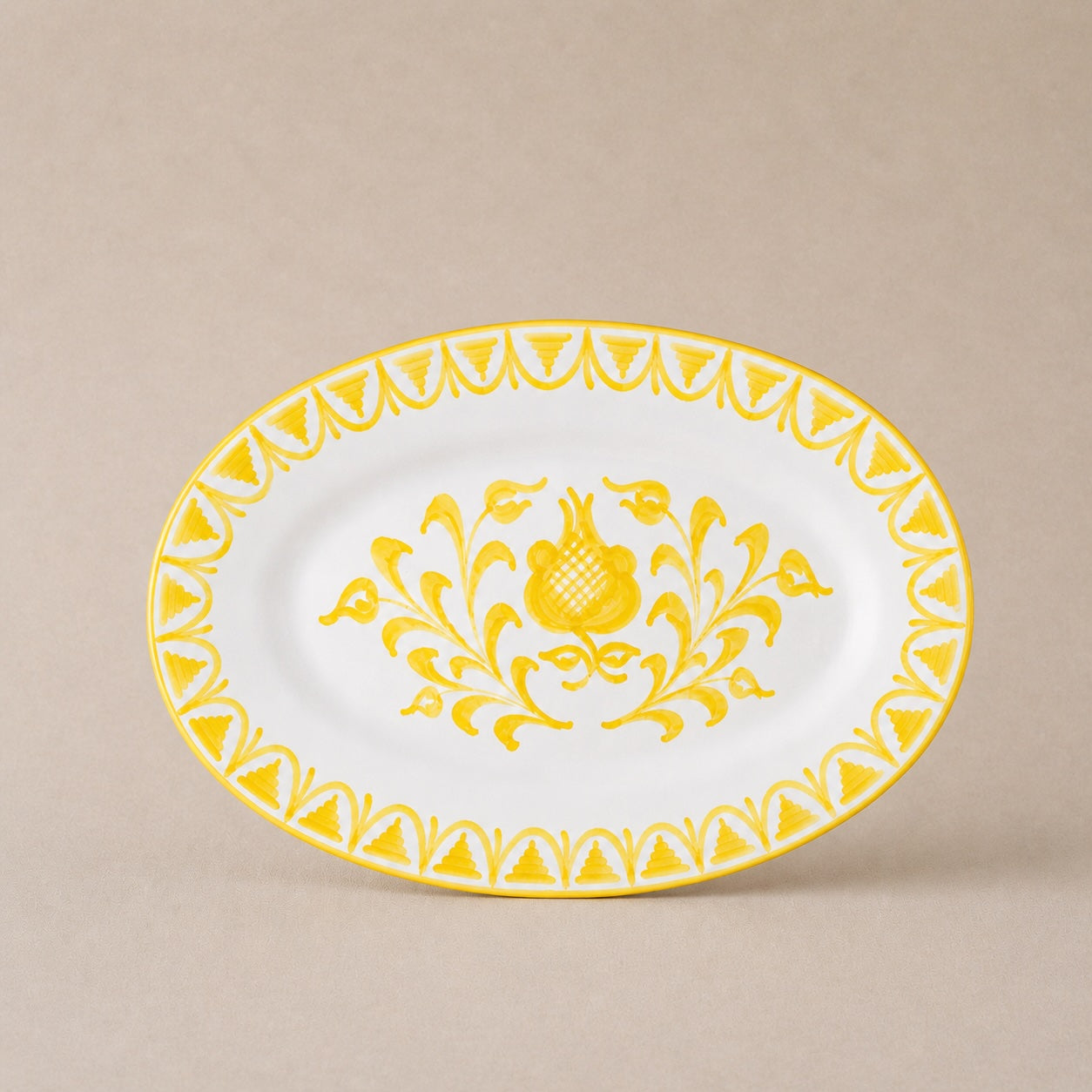Decorative plate with yellow floral design on a beige background