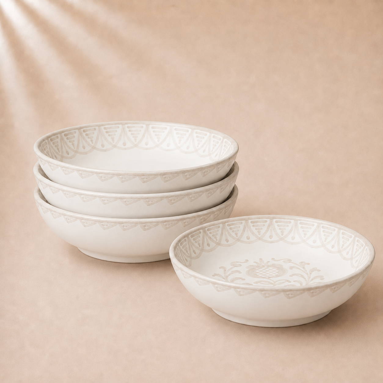 Set of white ceramic bowls with lace-like patterns on a beige background