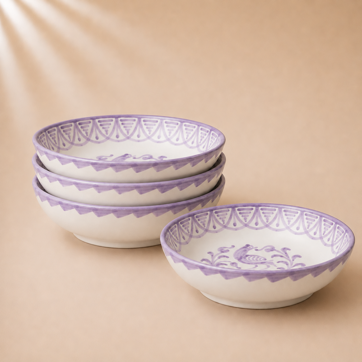 Set of ceramic bowls with purple decorative rims on a beige background