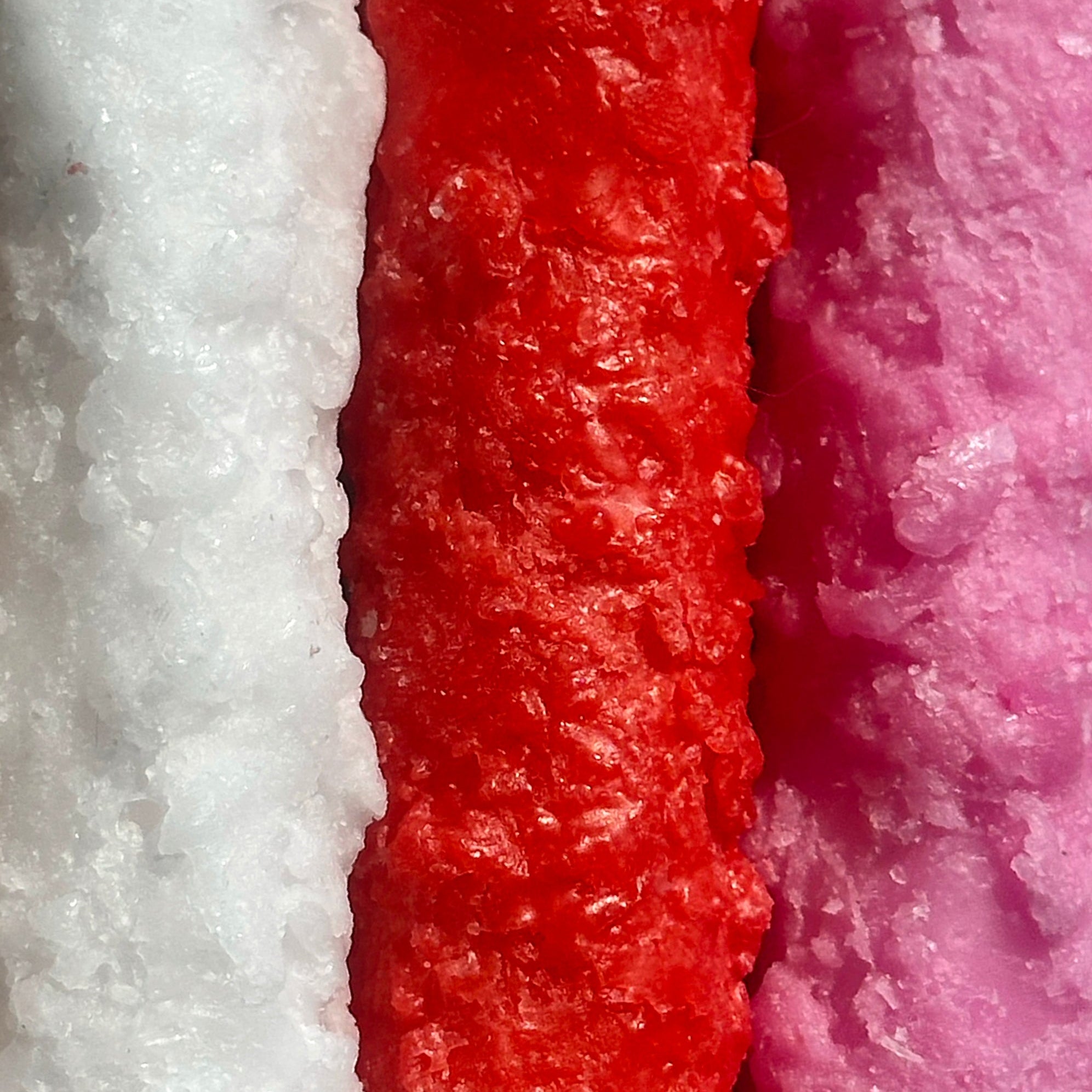 Close-up of textured red, white, and pink materials