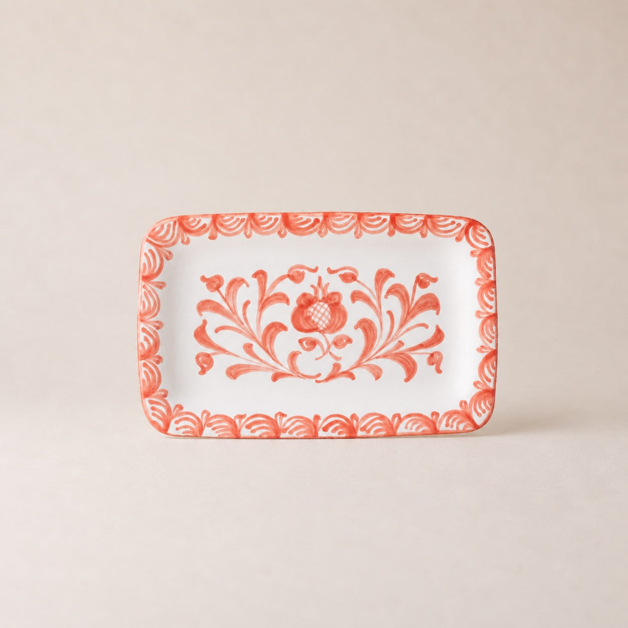Rectangular plate with red floral pattern on a beige background