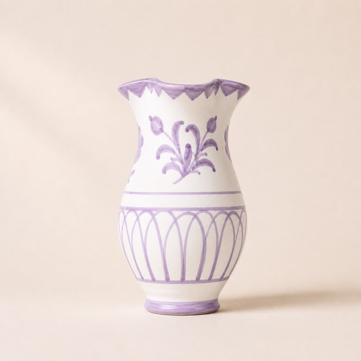 White vase with purple floral patterns on a beige background