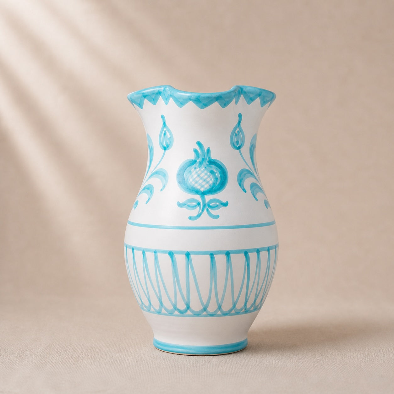 White vase with blue decorative patterns on a beige background